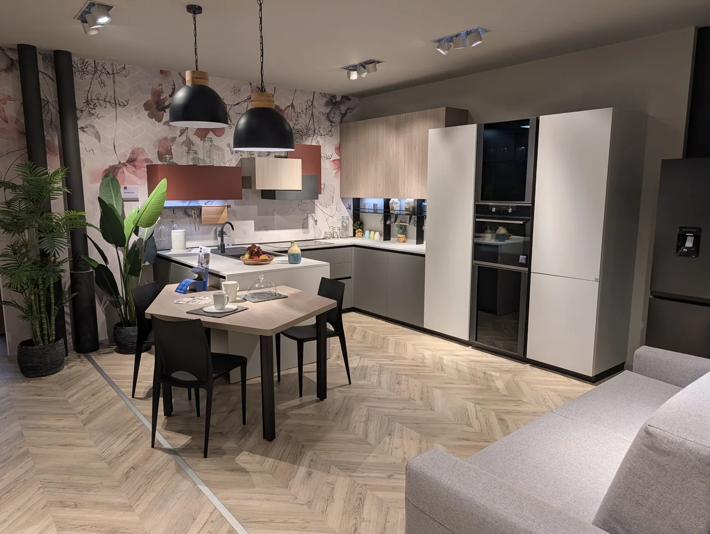 Cucina angolare con penisola e colonne chiare in esposizione a Veduggio